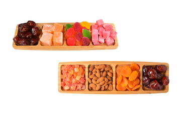 Wooden plate with cashew, marmalade and sweet turkish delight. Isolated on white background. Space for text or design.