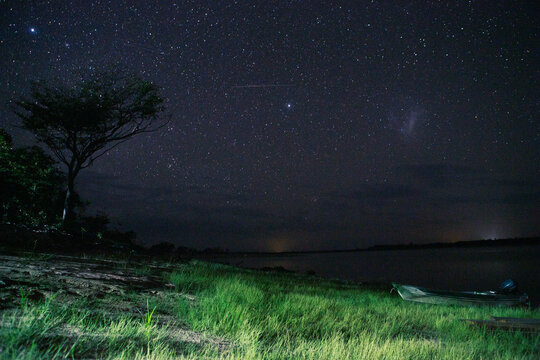 Panoramic view of the twilight over a large river in amazonia, Brazil. Beautiful sky full of stars on the nightfall. Space for text.