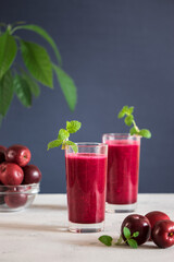 fresh apple smoothie with mint sprig on gray background