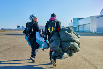 skydivers in the field after landing