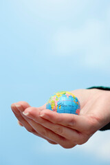 Closeup Of Hand Holding Globe