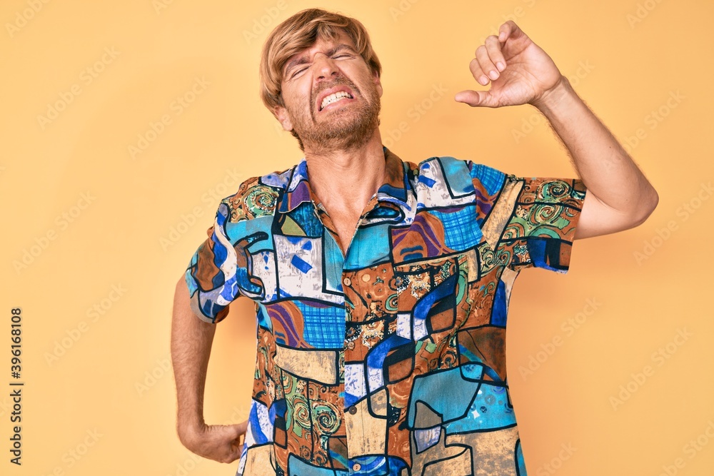 Sticker young blond man wearing summer shirt stretching back, tired and relaxed, sleepy and yawning for earl