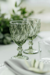 Close up crystal glasses at the table with the place for your text. Empty wine glasses. Alcohol party