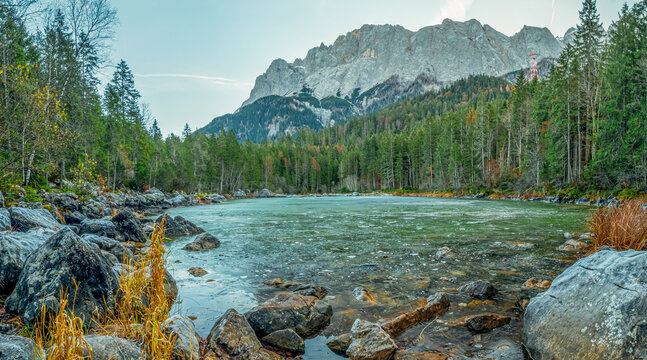 Frozen lake during winter with majestic Zugspitz Mountain background