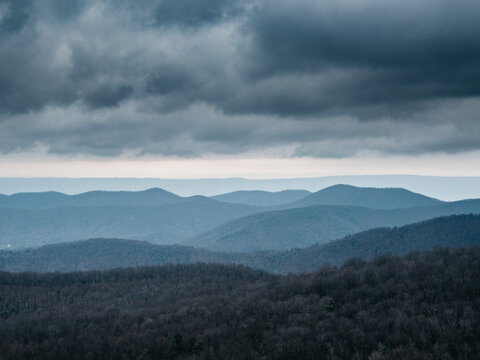 clouds over layers of mountains. View of Blue Ridge Mountains from Skyline Drive on a cold cloudy day in Winter. © Somsubhra
