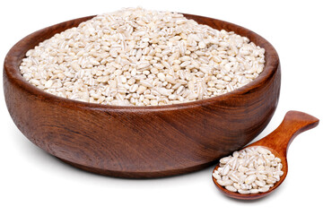 Pearl barley grains in a wooden bowl with a spoon