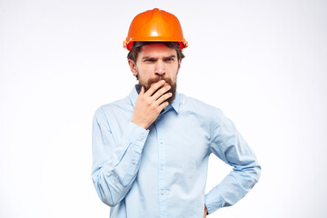 Man in blue shirt orange hard hat professional construction safety engineer