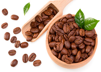 roasted coffee beans with green leaves and wooden spoon in wooden bowl isolated on white background. Clipping path and full depth of field. Top view