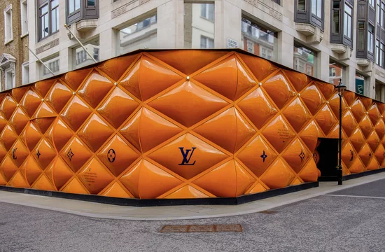 London, U.K, March 2019, building site fence panels for a Louis Vuitton  shop in the Mayfair area Stock Photo