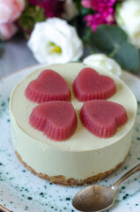 Cheesecake with matcha tea and jelly hearts