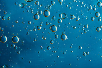 water droplets in oil, macro photo, blue background