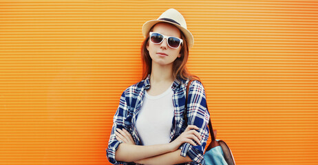 Portrait of young woman wearing a summer straw hat, shirt outdoors