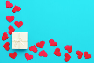 Valentine background made of white gift box and red hearts. Love and Valentine's Day concept
