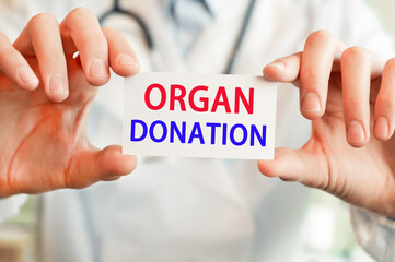 Doctor holding a card with text ORGAN DONATION, medical concept