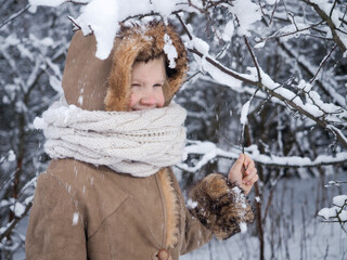 A child in a snow-covered forest