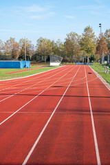 Red running lane on outdoor school stadium