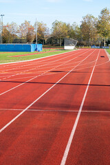 Red running lane on outdoor school stadium