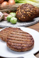 Fototapeta na wymiar Grilled plant based, meat free vega burgers close up