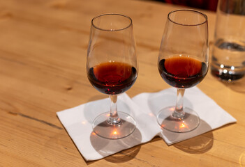 Professional tasting of different fortified dessert ruby, tawny port wines in glasses in porto cellars in Vila Nova de Gaia, Portugal