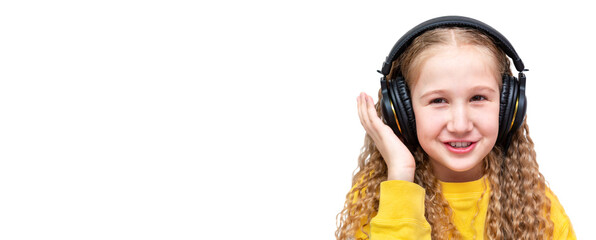 Caucasian cheerful girl with long hair in a yellow sweatshirt and wearing headphones, isolated on a...