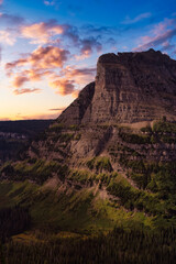 Beautiful View of American Rocky Mountains during Cloudy Summer Sunset or Sunrise. Dramatic Sky Composite. Landscape: Glacier National Park, Montana, United States.