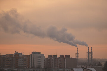 Smoking pipes from heating plants that supply heat to the city and the sky in the winter morning.