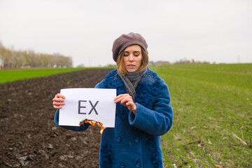 Woman hold paper with printed word Ex