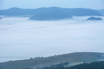 Beautiful sunrise in the Carpathian mountains with fog and dramatic sky