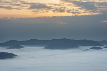 Beautiful sunrise in the Carpathian mountains with fog and dramatic sky
