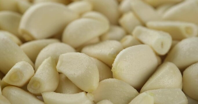 peeled garlic close up rotating