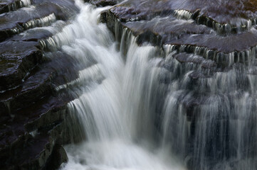 Jones falls soft waterfall with black layered rock