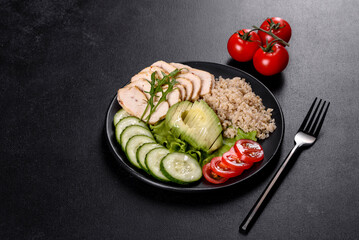 Fresh delicious salad with quinoa, chicken and fresh vegetables on a plate