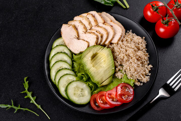 Fresh delicious salad with quinoa, chicken and fresh vegetables on a plate