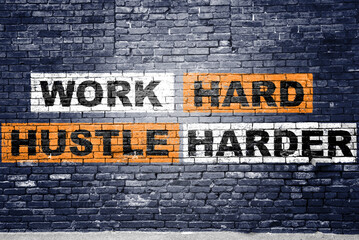 Fototapeta premium Work Hard Hustle Harder saying lettering Graffiti on Brick Wall