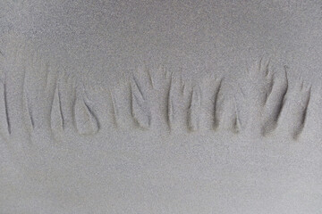 Minimalist beach scene of footprints in the sand. Background.