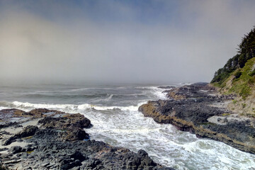 Incoming surf tide churns in narrow channel of Thor's Well on Cape Perpetua, Oregon coast.
