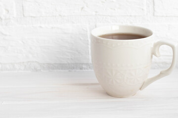 a Cup of black tea in white on a white background with space for text
