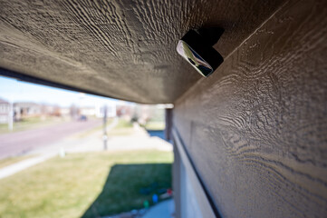 Selective focus on an outdoor security camera mounted under a roof overhang