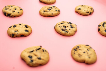 Cookies with chocolate on a pink background. Sweet background.