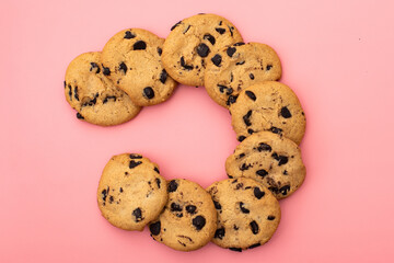 Cookies with chocolate on a pink background. Sweet background.