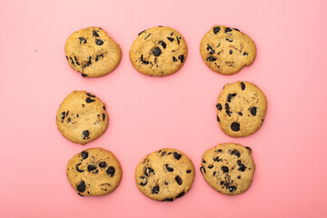 Cookies with chocolate on a pink background. Sweet background.