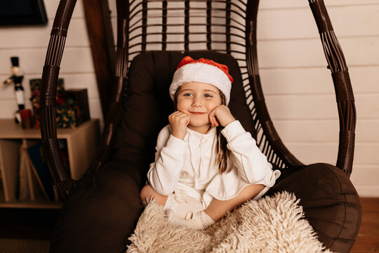 Happy joyful little girl wearing santa costume posing at home and waiting for christmas presents, New Year, Christmas