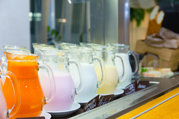 Yogurt and milk in glass jars standing in a row