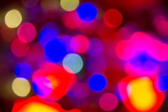 Red, Blue, Yellow And Purple Holiday Bokeh. Abstract Christmas Background.