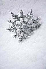 Snowflake in the snow. Christmas snow background. Christmas background picture.