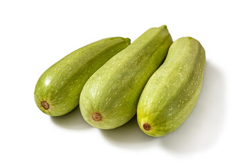 Three green zucchini on a white background
