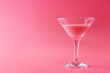 Pink cocktail in a glass on a pink background