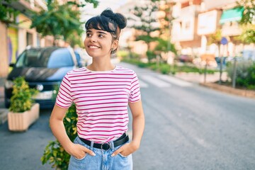 Young hispanic girl smiling happy walking at the city.