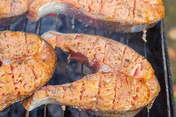 Large fish steaks fresh trout fried in spices on the grill