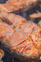 Large fish steaks fresh trout fried in spices on the grill
